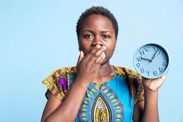 Shocked person looking at wall clock to check the time