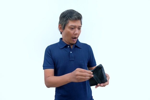 Shocked reaction of man holding an empty wallet