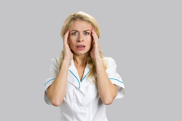 Shocked and scared female nurse or doctor