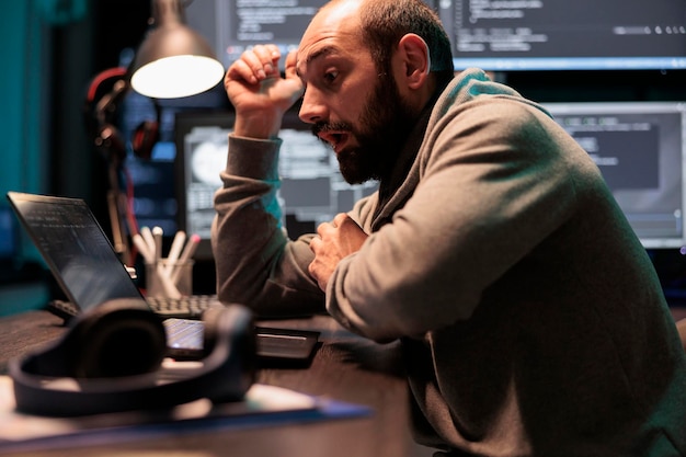 shocked surprised coder finding out good news on computer, working on software developing after hours. feeling excited and astonished in office, programming html script source code.