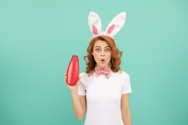 Shocked woman in easter bunny ears with shampoo