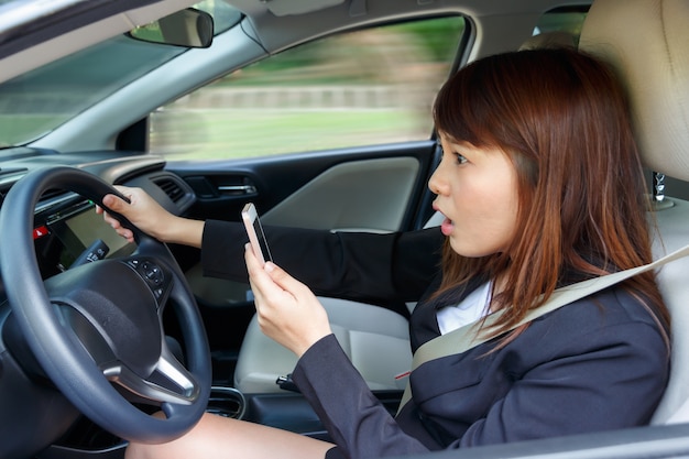 Shocked woman watching video or text to someone with smart phone