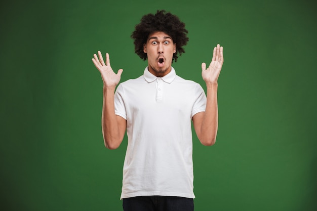 Shocked young african curly man 