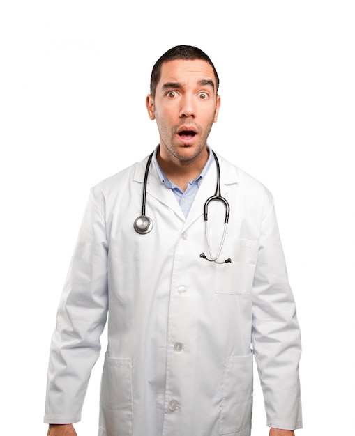 Shocked young doctor posing