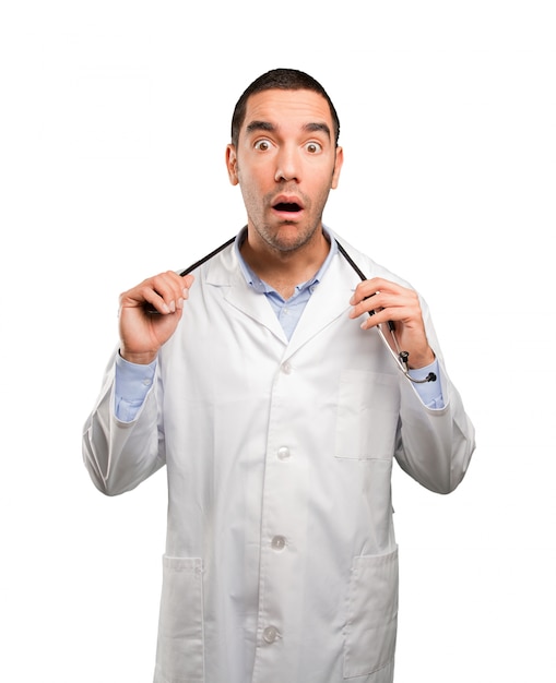 Shocked young doctor posing