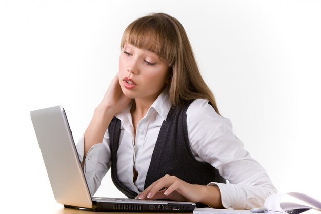 Shocked young girl is looking at a laptop