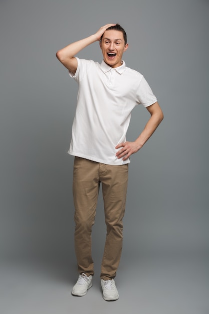 Shocked young man standing isolated