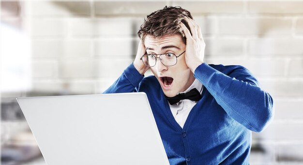 Shocked young man with laptop