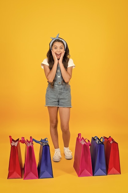 Shocking discount shopping day fashion boutique girl shopping
fashion shop little girl with shopping packages happy child in shop
with bags small child in summer style seasonal sales