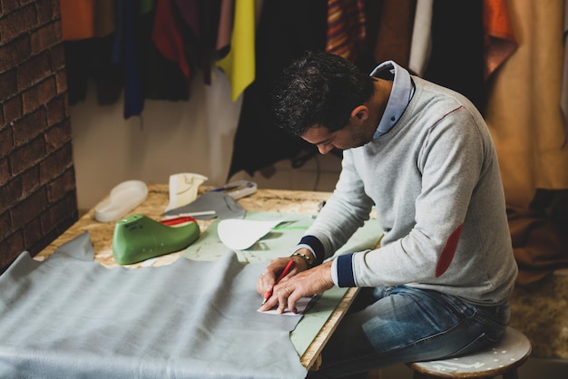 Shoe designer working with leather