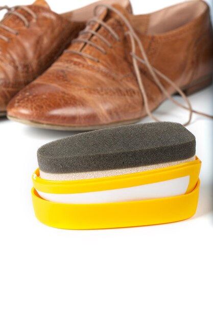 Shoe shine sponge on a gray background.