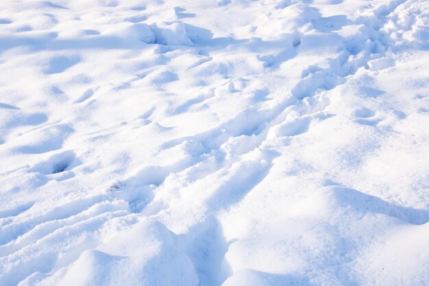 Shoe tracks on white snow close up