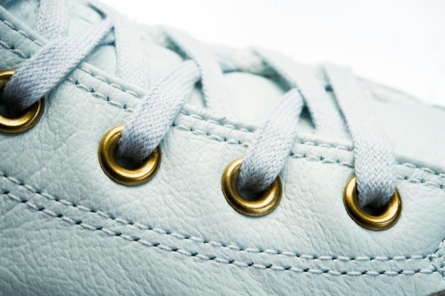 Shoelaces tied on sneakers with metal eyelets