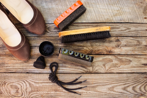  Shoes and care products for footwear on wooden table