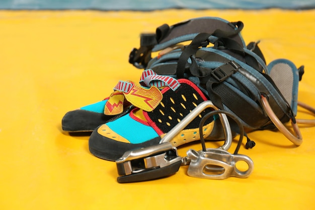 Shoes and climbing gear on sport mat