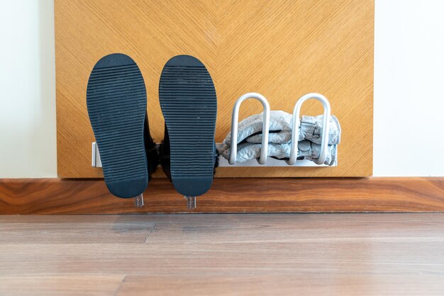 Shoes and gloves are dried on an electric wallmounted dryer