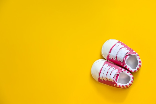 Shoes for newborns on a yellow. 