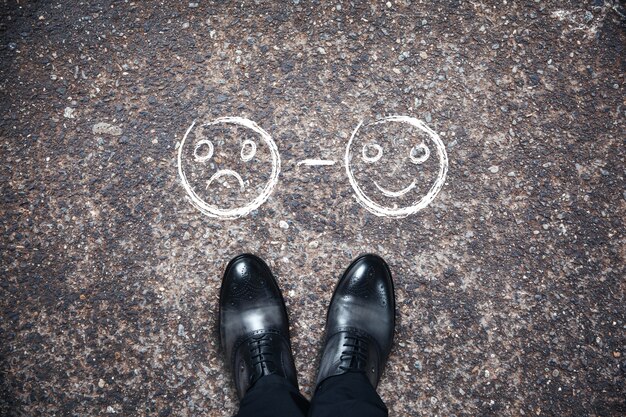 Shoes with smile on asphalt