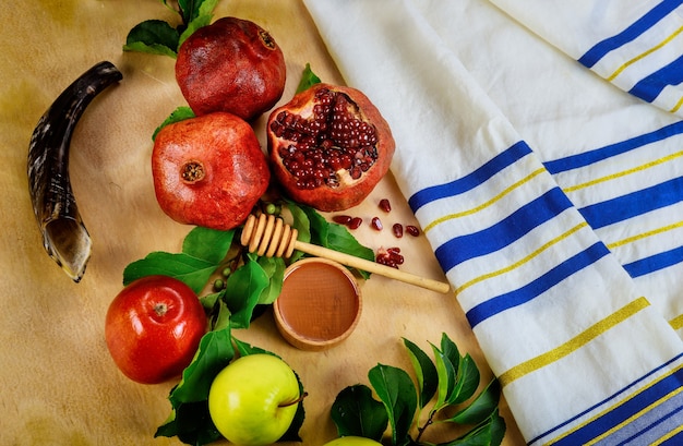 Shofar and food with talit for jewish holiday Rosh Hashanah. Top view.