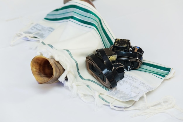 Shofar horn on white prayer talit room for text rosh hashanah jewish holiday concept traditional holiday symbol