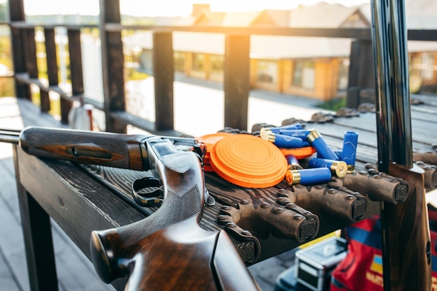 Shooting sports equipment for trap shooting on wooden table Airgun and bullets