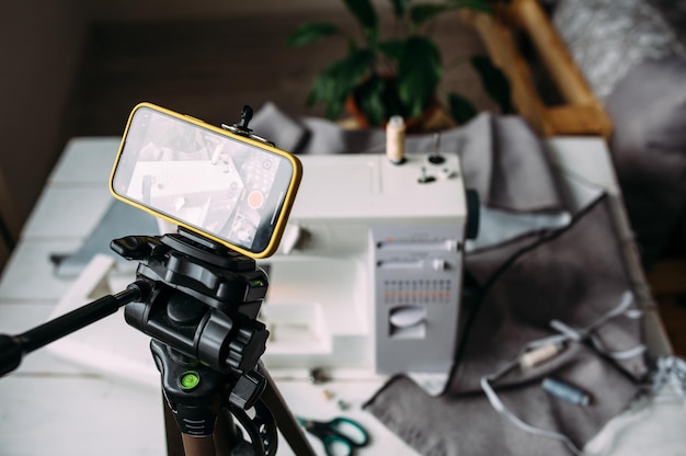 Shooting video of the sewing process workshop on clothing design on smartphone