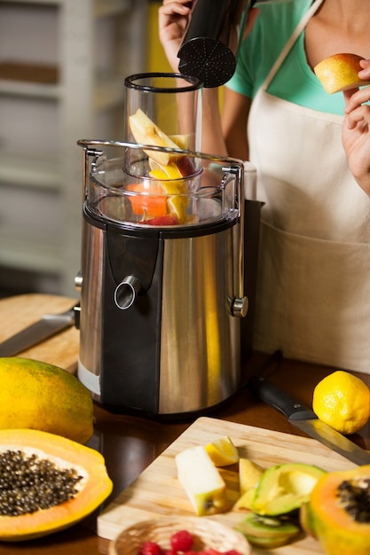 Shop assistant preparing juice at health grocery shop