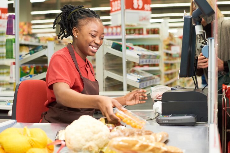 Photo shop assistant scanning food products and putting them on other side of counter
