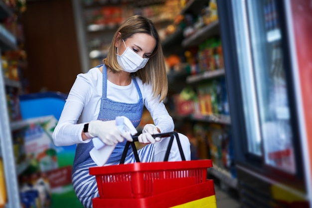 shop assistant working in medical mask disinfecting carts