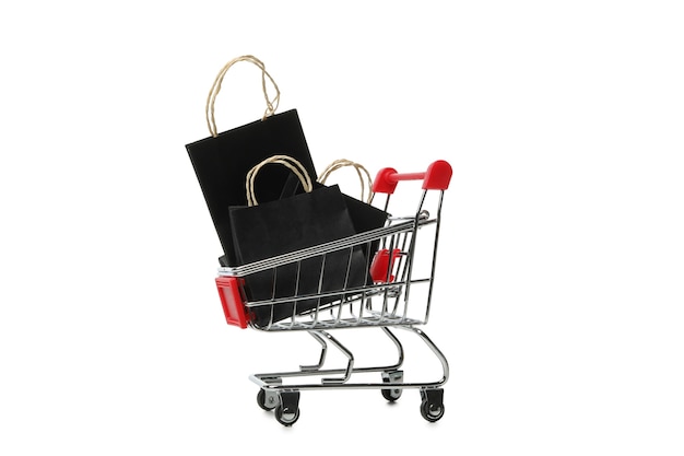 Shop cart with paper bags isolated on white