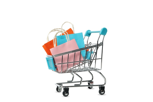 Shop cart with paper bags isolated on white 