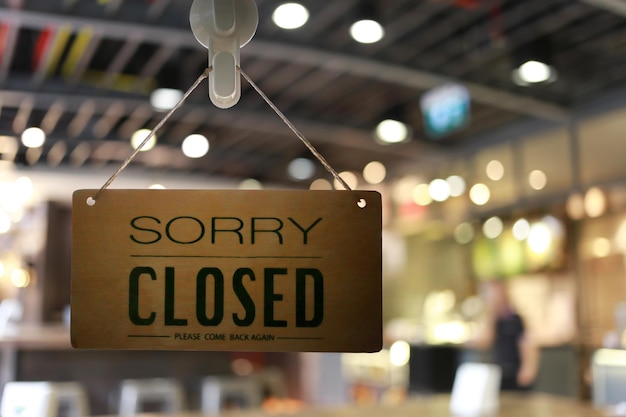 Shop closed of storefront sign,restaurant shows the closing\
status.