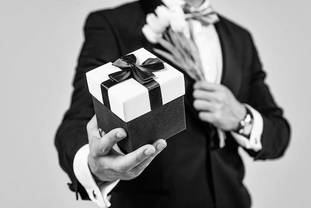 Shop the stores for gift ideas Present box in male hands Gift shop Floral arrangement Holiday celebration Festive occasion