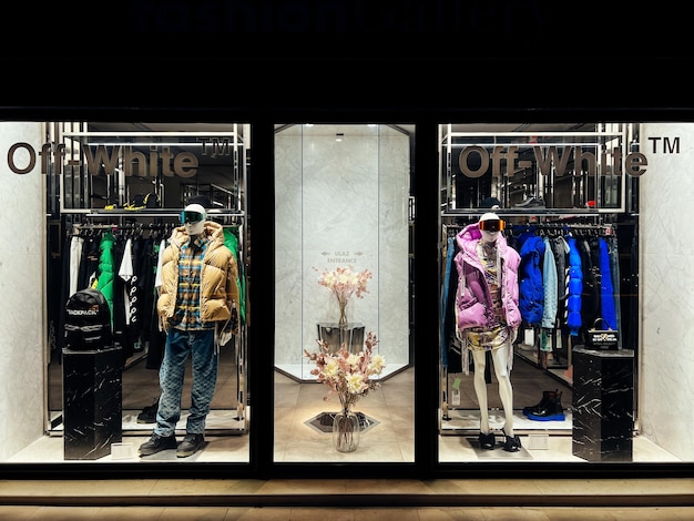 Photo shop window with men and women clothing caption offwhite