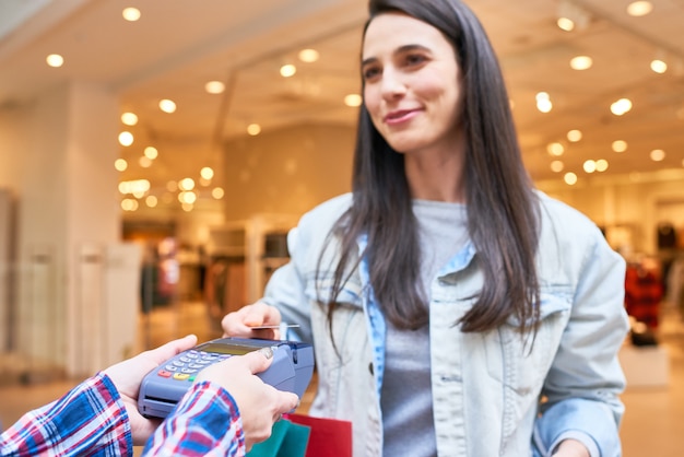 Shopaholic spending money in the shop