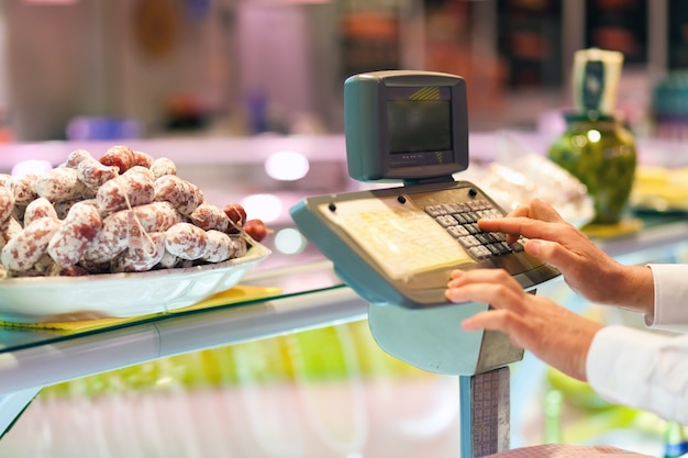 Shopkeeper cheking the food weight