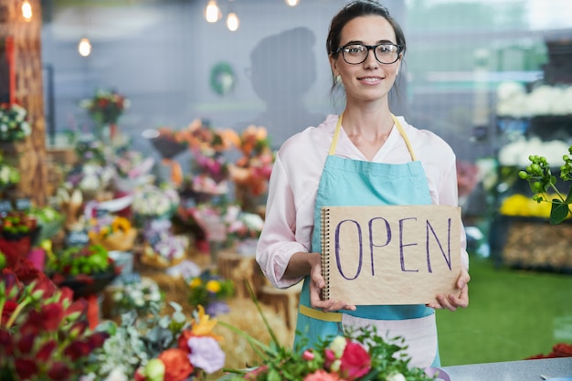 Shopkeeper Holding OPEN Sign