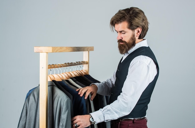 Shopper hipster man in fitting room menswear store formal style concept