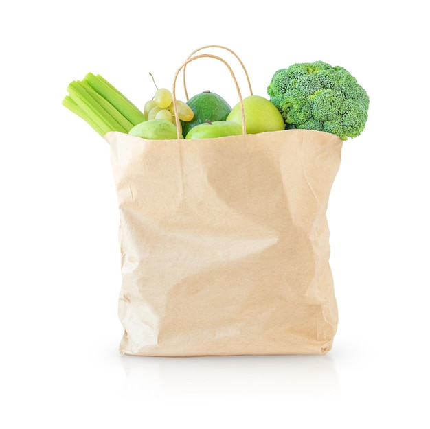 Shopping bad with green food isolated on white