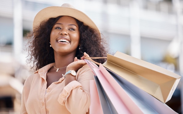 Shopping bag happy black woman and travel customer smile for discount sales thinking of luxury fashion choice and market in summer Wealthy rich and smile consumer on vacation in Ibiza Spain city