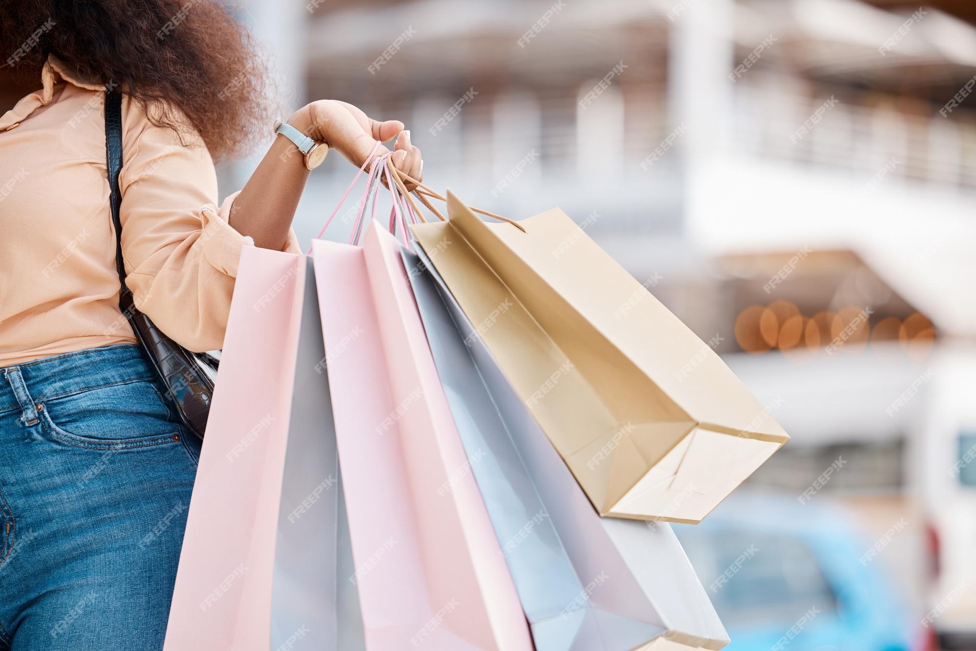 Premium Photo  Shopping bag sale and walking woman in the city of new york  for fashion retail and discount hands of a girl with bags in the street  from a boutique