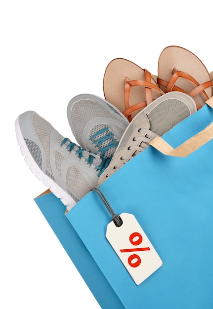 Shopping bag with footwear isolated on white background