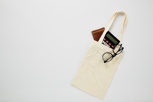 Shopping bag with personal accessories over white background