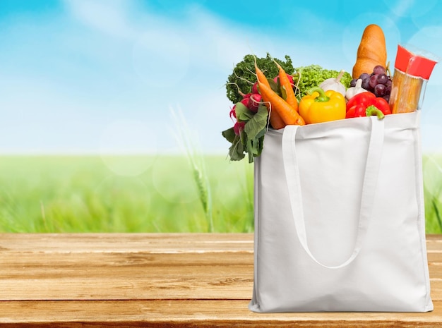 Shopping bag with variety of grocery products, close-up view