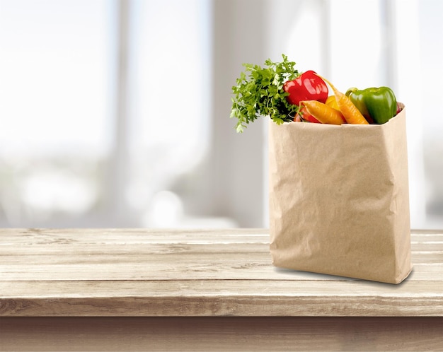 Shopping bag with variety of grocery products, close-up view