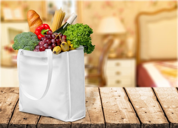 Premium Photo | Shopping bag with variety of grocery products, close-up ...