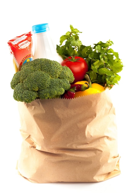 Shopping bag with variety of grocery products, close-up view