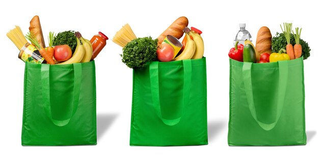 Photo shopping bags with groceries isolated on white