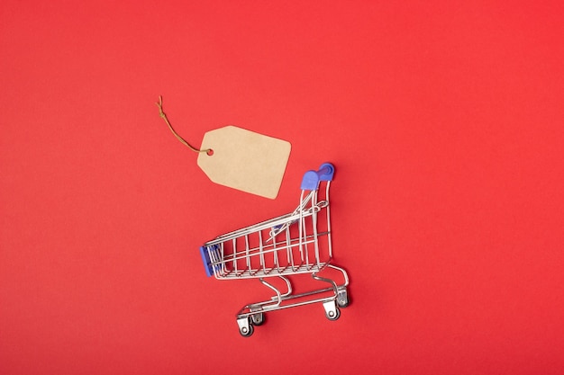 Shopping basket and label with place to add text on a red background.