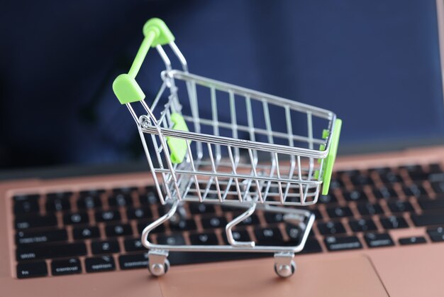 Shopping basket on the laptop keyboard. Online sales in online stores concept